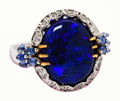 A black opal, diamond and sapphire ring.