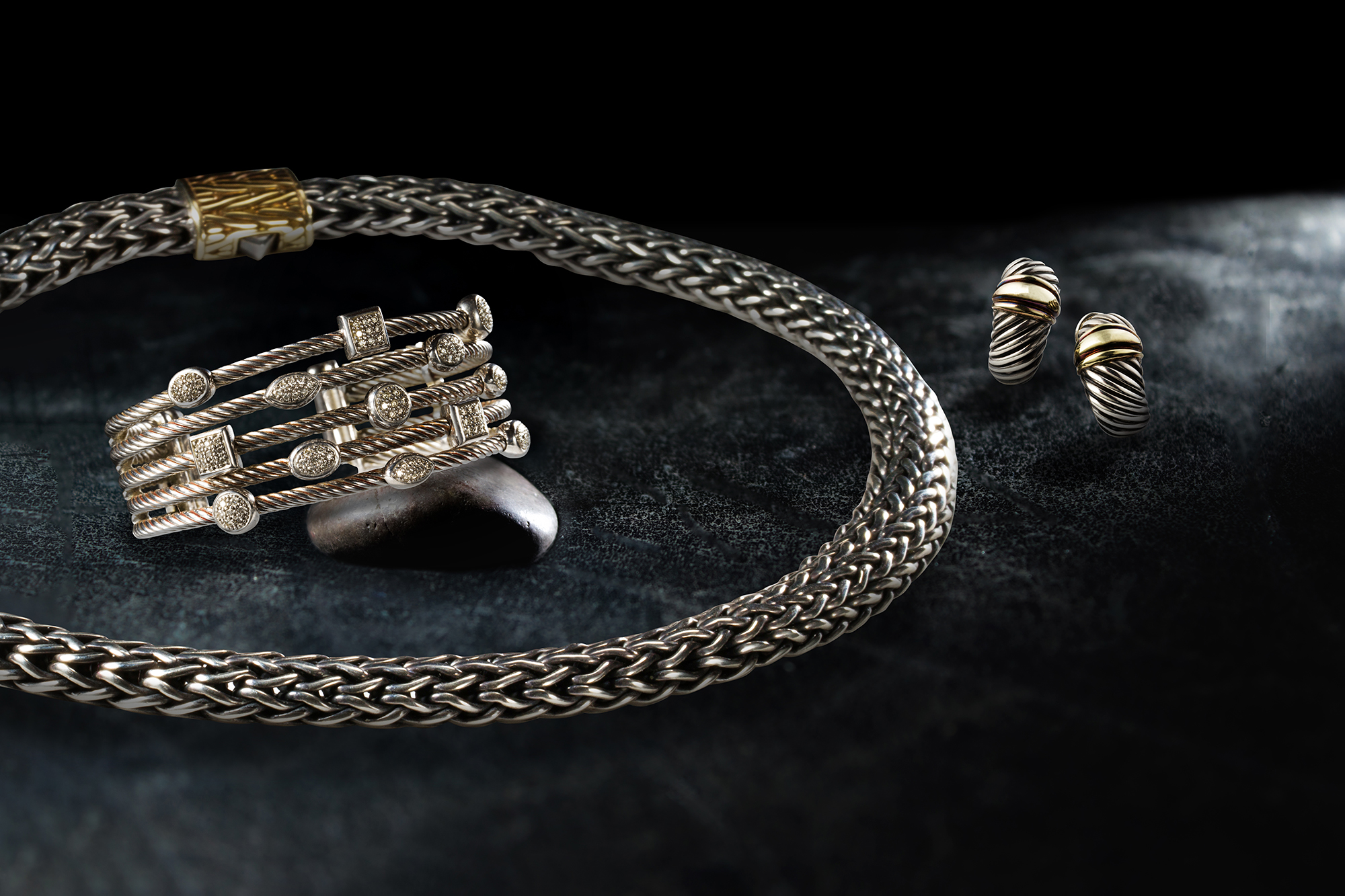 Left: A diamond and sterling silver bracelet, David Yurman. Right: A sterling silver and eighteen karat gold necklace and ear clips suite, John Hardy.