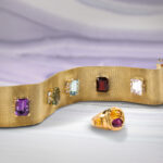A gem-set 18k gold bracelet and a yellow, pink sapphire and 18k gold ring.