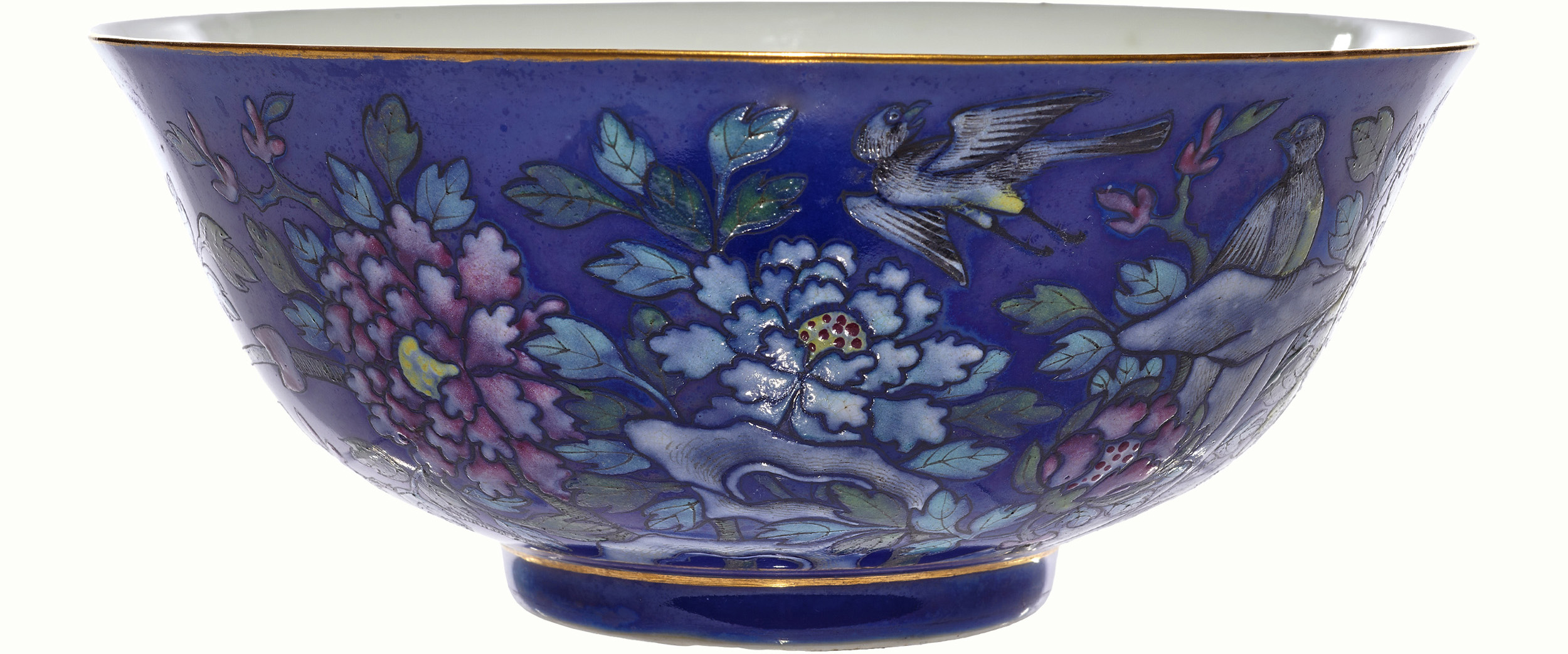 A Chinese famille rose blue ground bowl decorated with bird and floral motifs and one dragon inside the bowl, bearing Guangxu six-character mark, 6.625″ across.