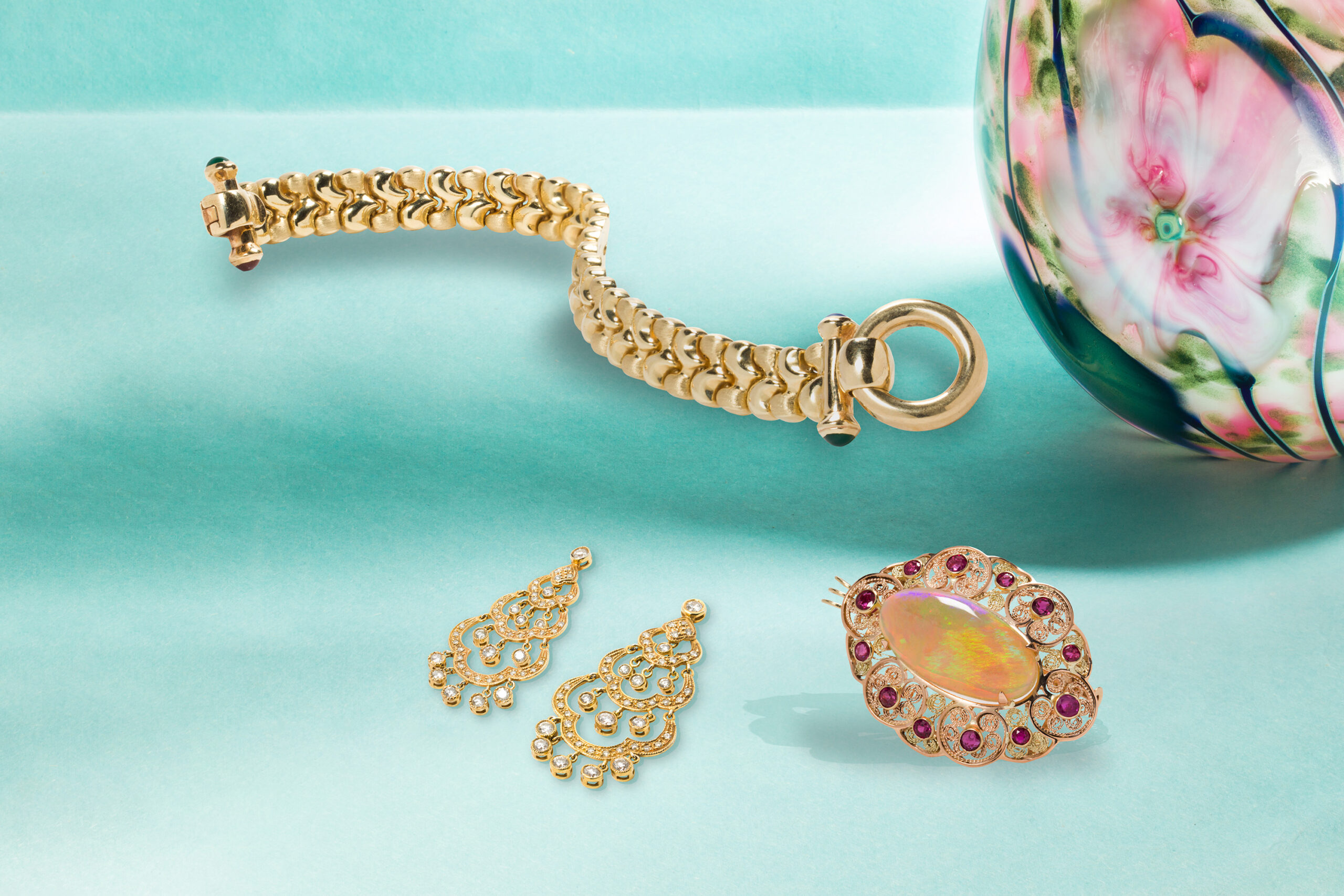 A gemstone and 14k gold bracelet. Estimate: $500–$700; A pair of diamond and 14k gold earrings. Estimate: $1,500–$2,500; An opal, ruby and 14k rose gold pendant. Estimate: $2,000–$3,000