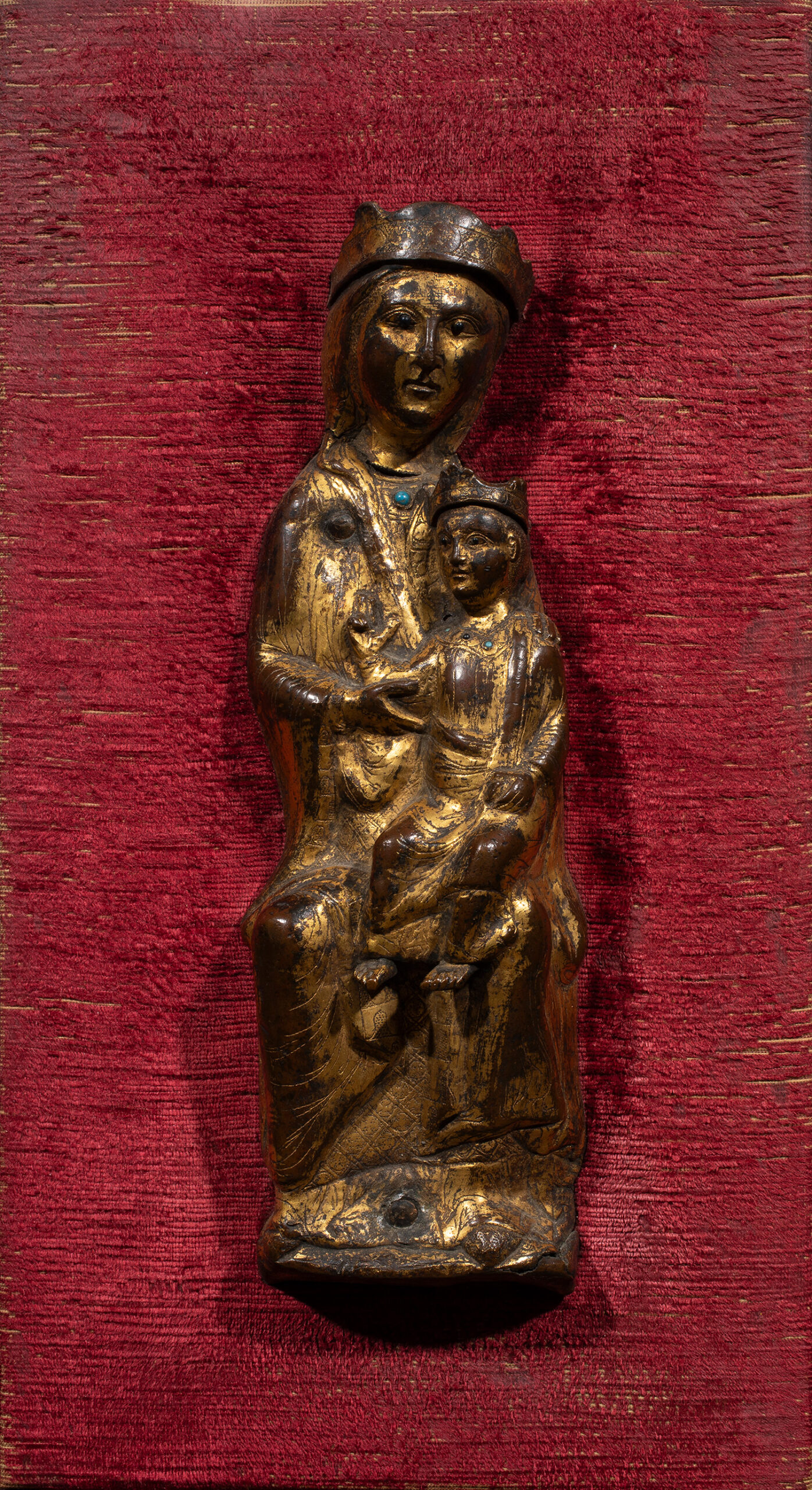 A French gilt bronze figure of Madonna and Child mounted on red velvet plaque.Sold: $47,250