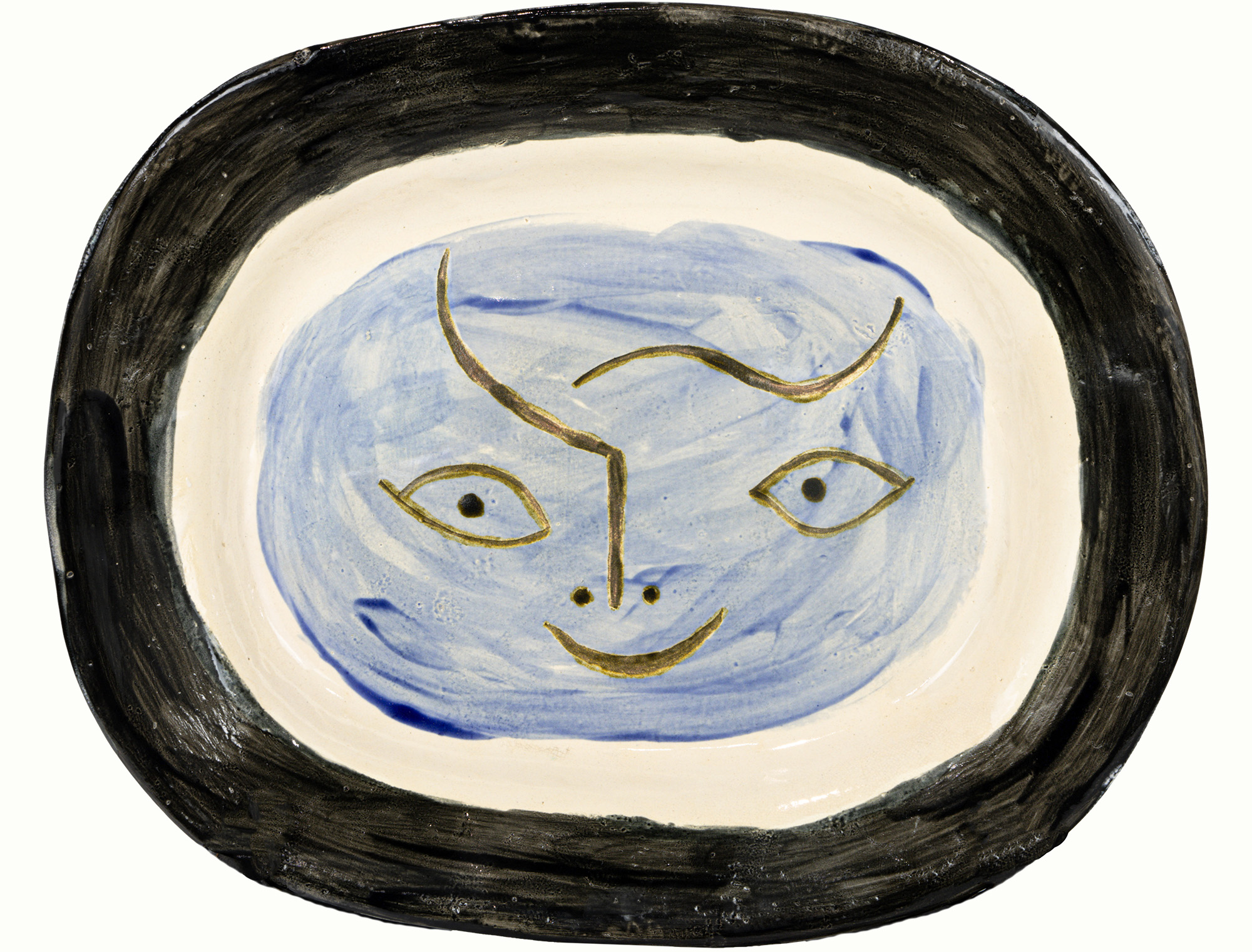 Pablo Picasso (Spanish, 1881–1973), <em>Plat à la Tête de Faune</em>, 1948, partially engraved white earthenware ceramic plate with colored engobe and glaze, 12.5″ x 15.5″ x 2″.