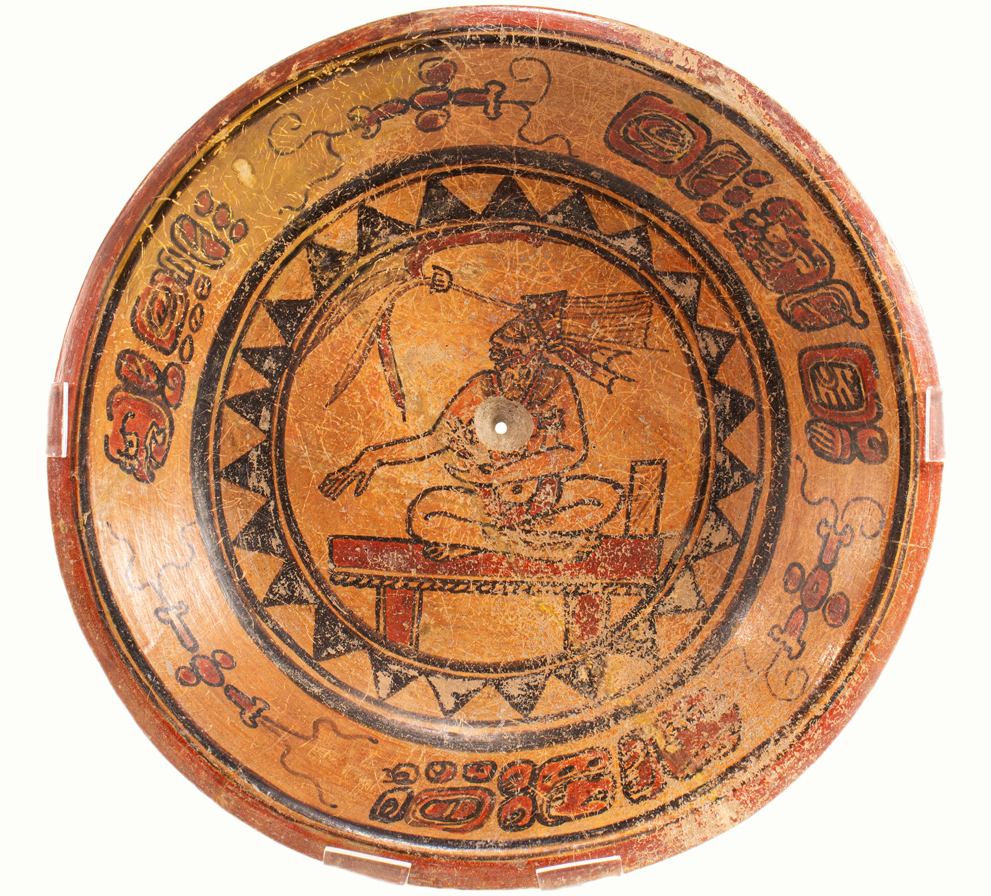 A Mayan plate depicting a priest on throne.Estimate: $1,800–$2,500