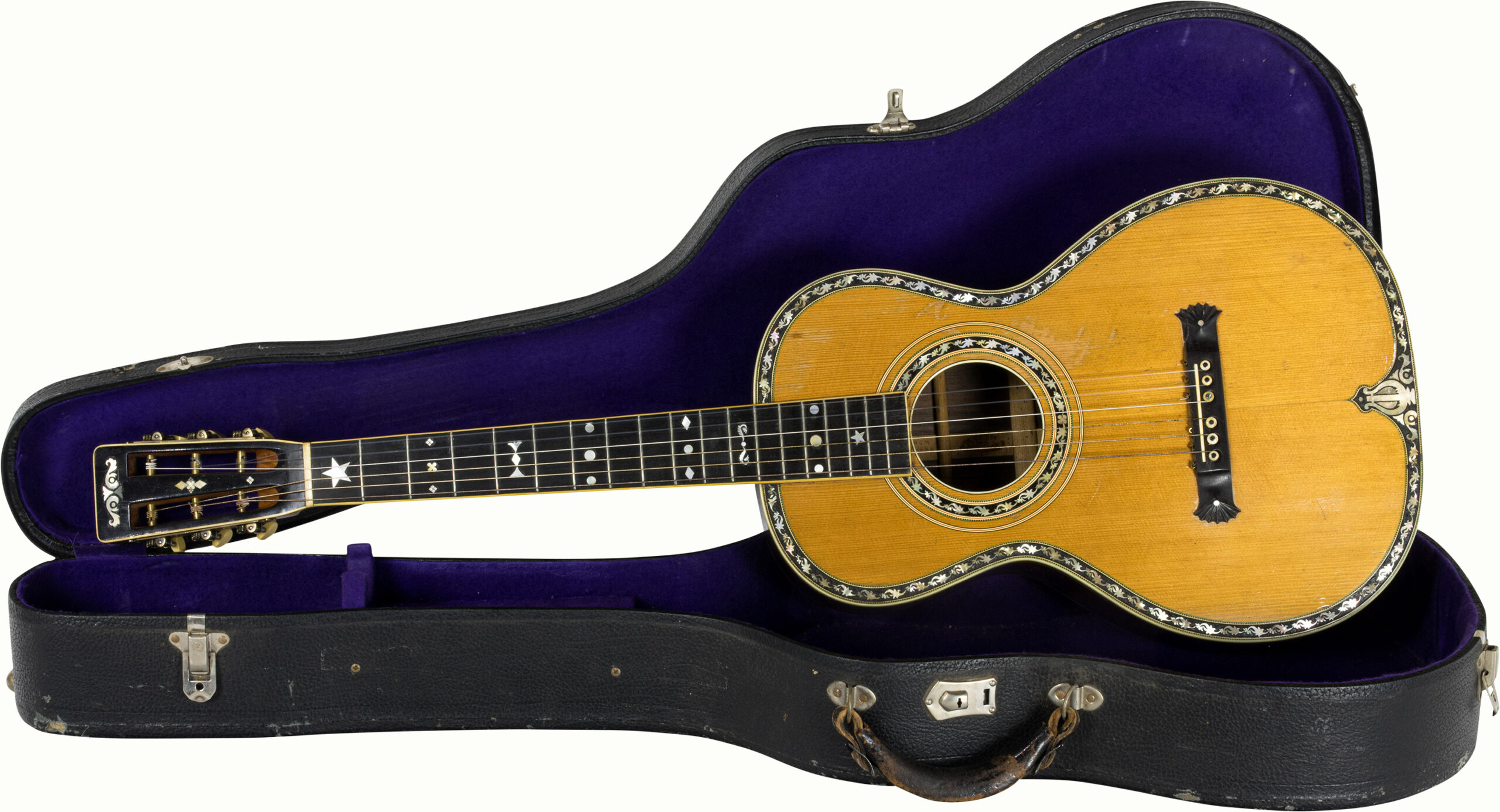 A Washburn Style 208 Grand Concert guitar with mother of pearl decoration, marked 2031-6, with hard case. Please note this guitar was offered at Guernseys as lot 38 in their April 2014 auction.<br><b>Estimate: $5,000–$7,000</b><br><em>This property is being sold at public auction as provided by Internal Revenue Code section 6335. Only the right, title, and interest of the Hank Risan is being offered for sale. Property is sold “as is, where is” without recourse against the United States. The United States offers no Guarantee or warranty, implied or expressed on the condition of any property or its fitness for any purpose or use.</em>