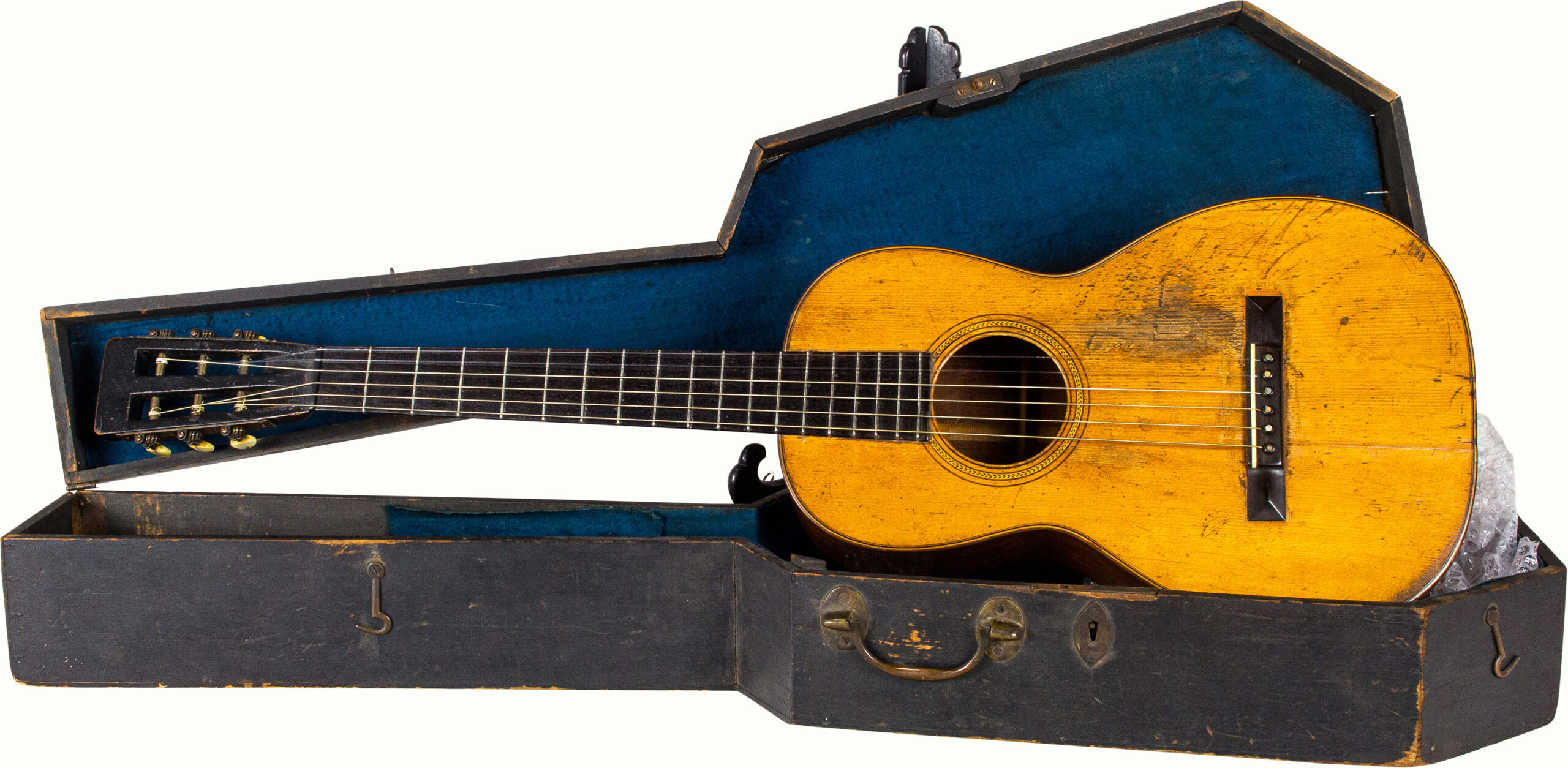 A C.F Martin New York acoustic guitar, with ebonized wood case, with signed fragment signed Mark Twain/Samuel Clemens (very poor and illegible). <br><b>Estimate: $5,000–$7,000</b><br><em>This property is being sold at public auction as provided by Internal Revenue Code section 6335. Only the right, title, and interest of the Hank Risan is being offered for sale. Property is sold “as is, where is” without recourse against the United States. The United States offers no Guarantee or warranty, implied or expressed on the condition of any property or its fitness for any purpose or use.</em>