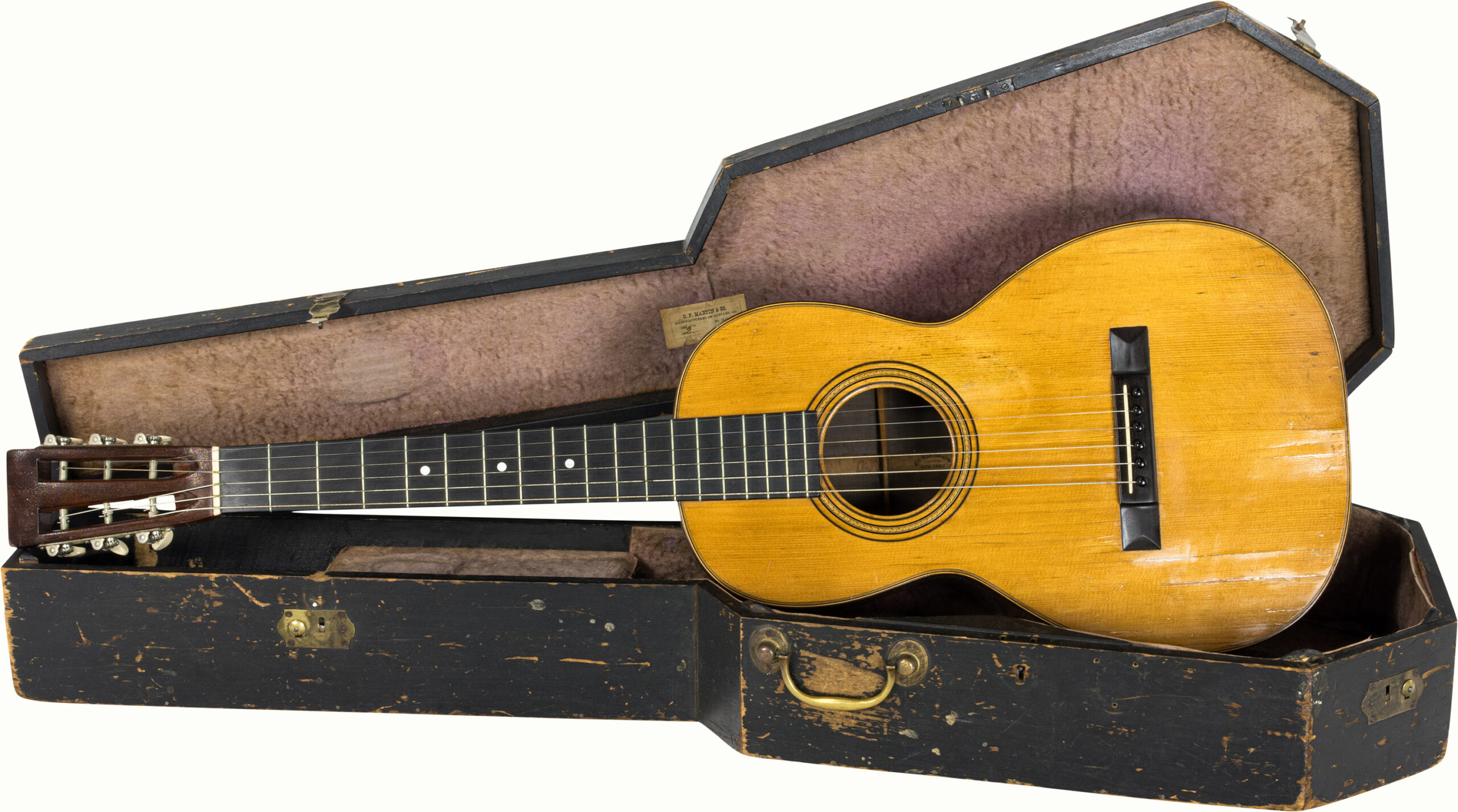 A C. F. Martin & Co. New York guitar, with original case and label reading C.F Martin and Co. Manufacturers of Guitars, etc. / Size of G 2 and No. of Qual 27.<br><b>Estimate: $5,000–$7,000</b><br><em>This property is being sold at public auction as provided by Internal Revenue Code section 6335. Only the right, title, and interest of the Hank Risan is being offered for sale. Property is sold “as is, where is” without recourse against the United States. The United States offers no Guarantee or warranty, implied or expressed on the condition of any property or its fitness for any purpose or use.</em>
