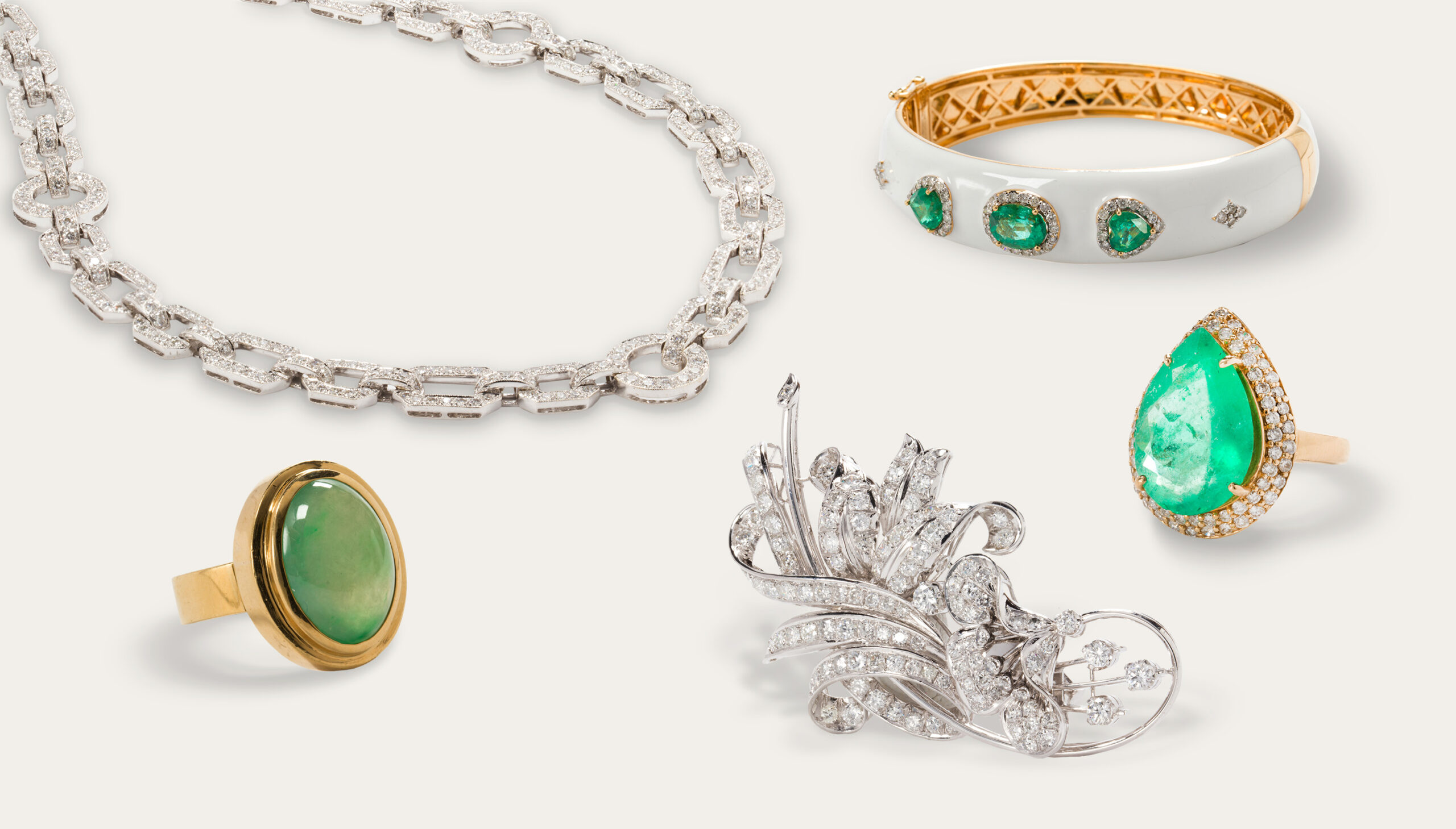 From left to right: A diamond and 18k gold necklace. Estimate: $3,000–$5,000; A honey jade and 18k gold ring. Estimate: $2,000–$3,000; A diamond and platinum brooch. Estimate: $2,500–$3,500; An emerald, white enamel and 18k gold bangle. Estimate: $7,000–$10,000; An emerald, diamond and 14k gold ring. Estimate: $2,000–$3,000