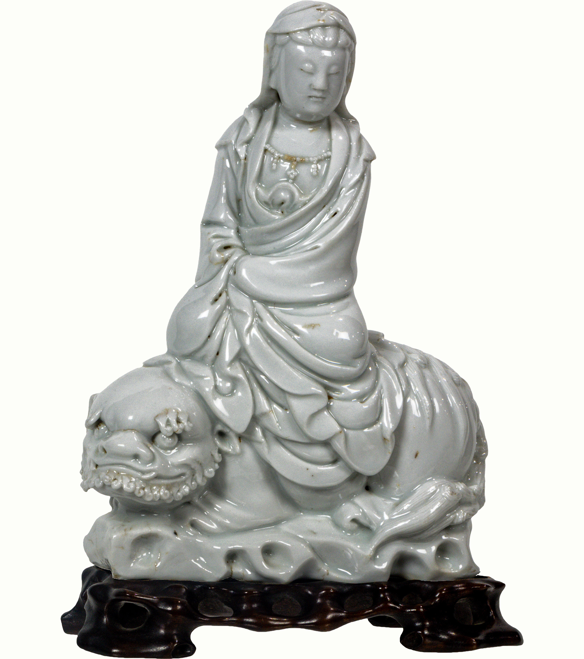 A Chinese Dehua seated figure of Guanyin, 19th century. Estimate: $600–$900