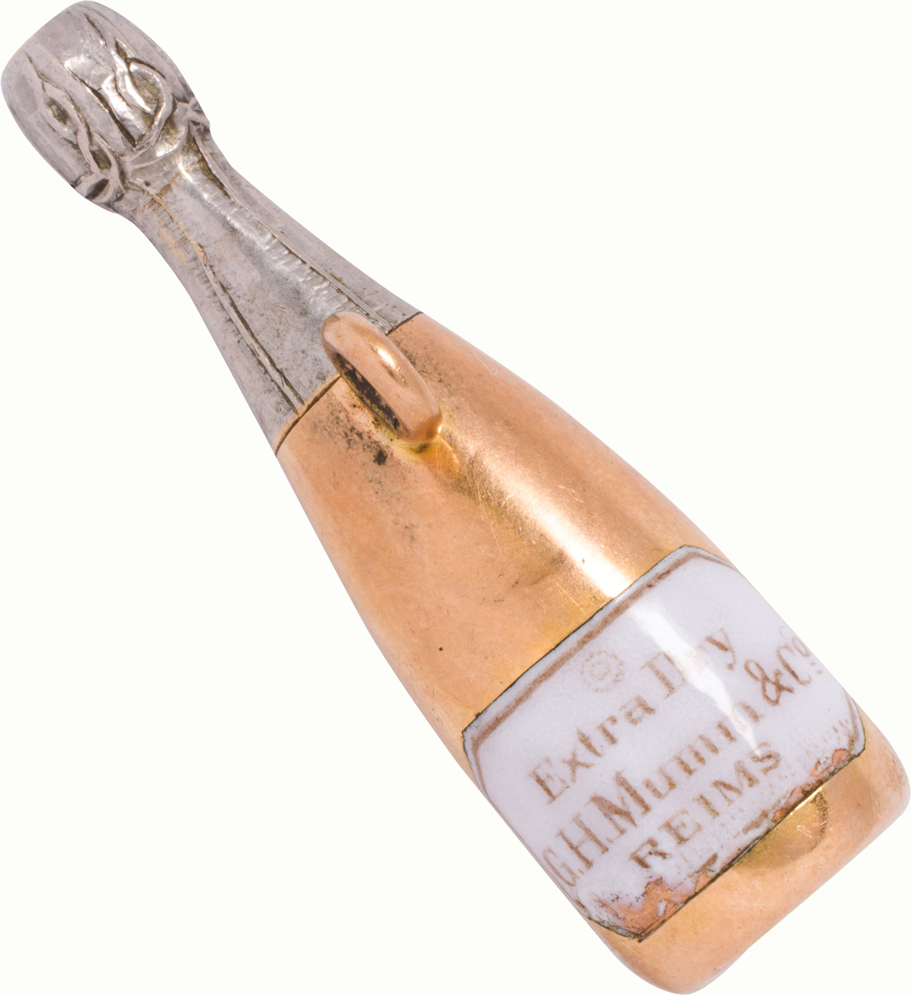 An antique enamel and 15k bi-color gold champagne bottle taxi whistle. Estimate: $300–$500