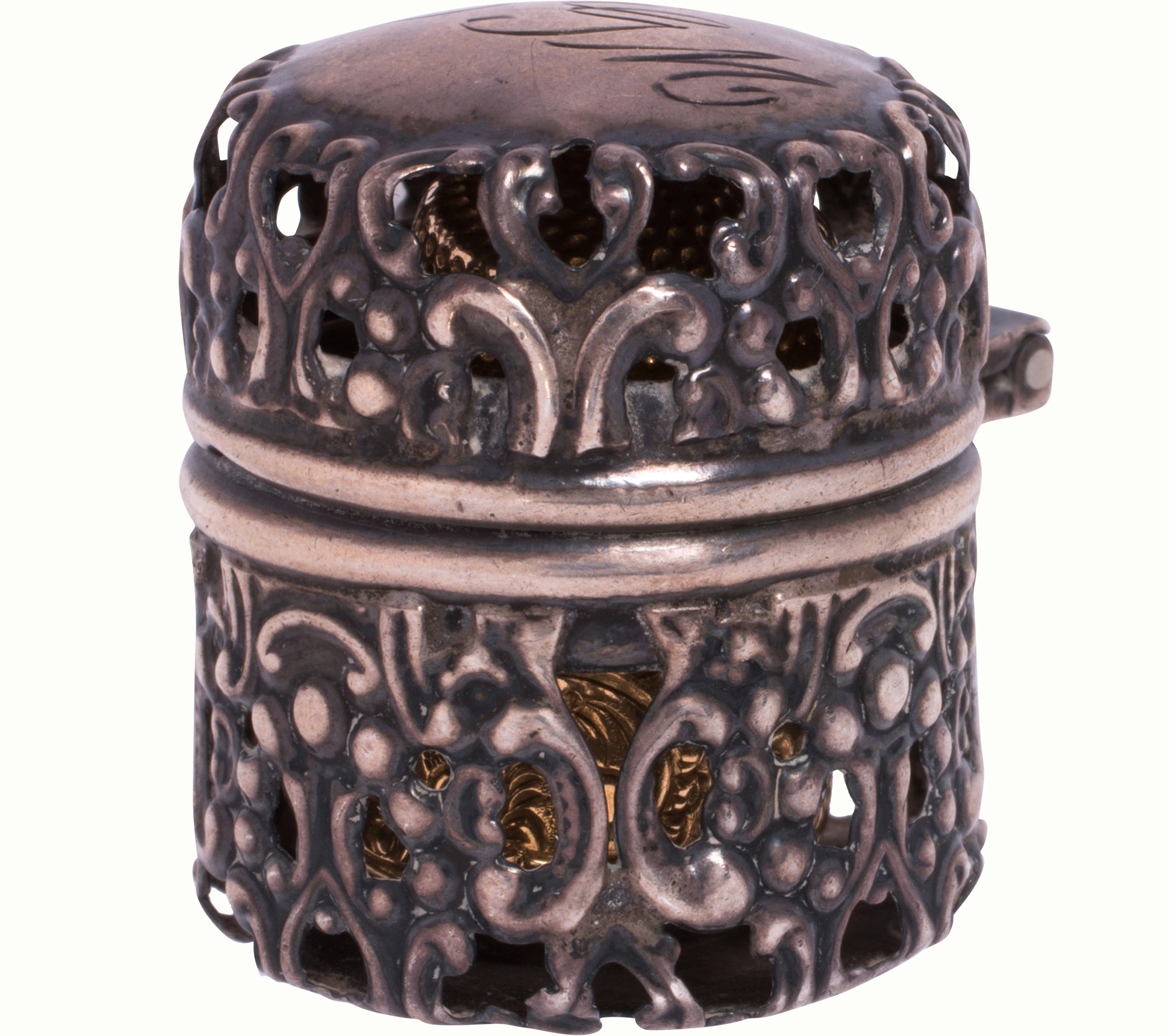An antique sterling silver thimble holder with 14k gold thimble. Estimate: $300–$500