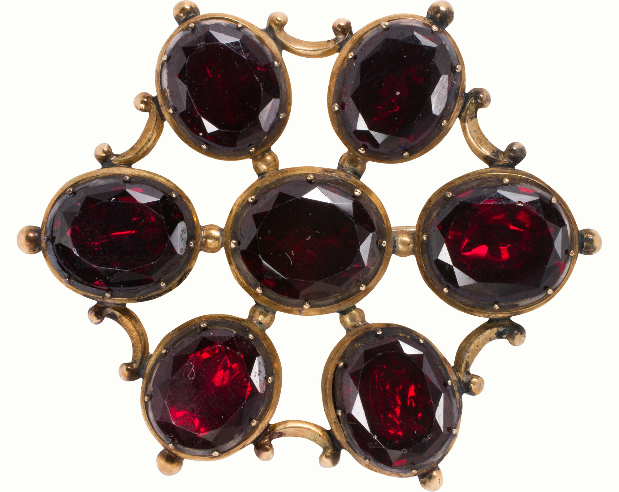 An antique garnet, 14k gold, and silver brooch. Estimate: $600–$800