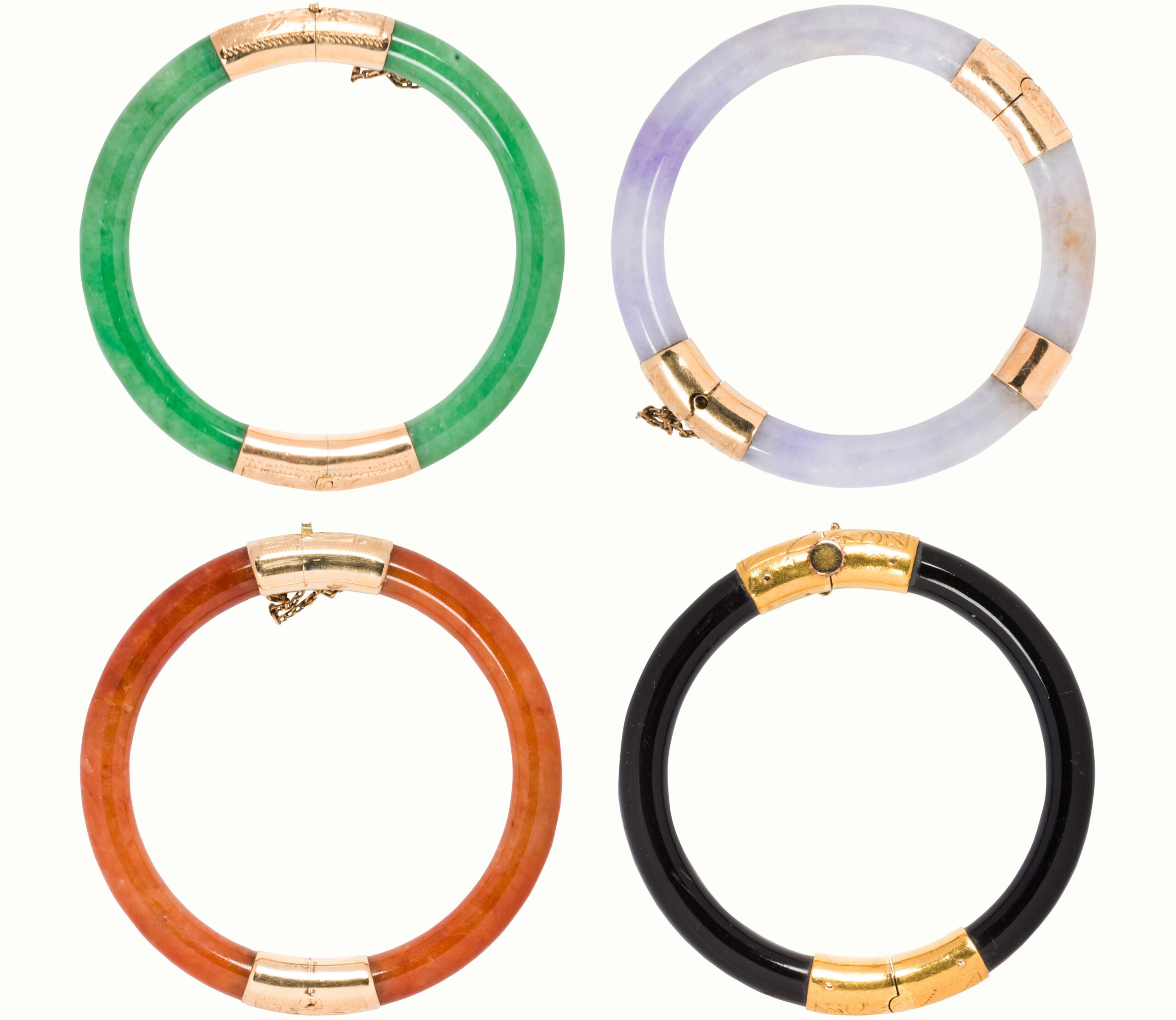 A group of four jade, coral and gold bangle bracelets bangles. Sold: $5,040